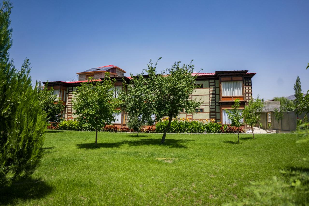 Lush green garden with outdoor seating and mountain views